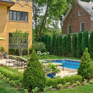 Photo of a mid-sized victorian backyard patio with a water feature, natural stone pavers and a pergola.
