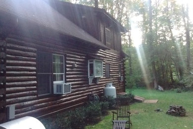 Example of a large mountain style brown two-story wood exterior home design in Philadelphia with a shingle roof