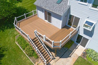 Large trendy backyard ground level metal railing deck photo in Detroit with no cover