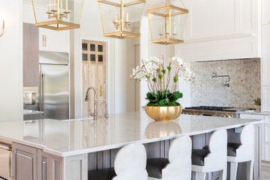 Example of a large transitional porcelain tile and beige floor kitchen design in Orlando with a farmhouse sink, raised-panel cabinets, light wood cabinets, quartzite countertops, multicolored backsplash, marble backsplash, stainless steel appliances, an island and white countertops