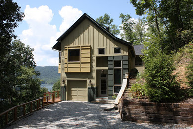 Inspiration for a large rustic green two-story wood gable roof remodel in Charlotte