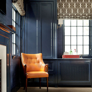 Inspiration for a modern home office and library in San Francisco with blue walls, carpet and a standard fireplace.