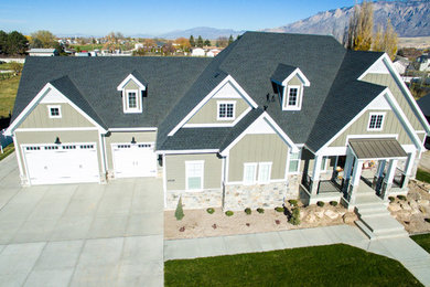 Example of a large arts and crafts beige one-story mixed siding exterior home design in Other with a shingle roof