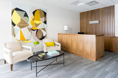 Example of a large minimalist built-in desk carpeted and gray floor home office design in Los Angeles with white walls