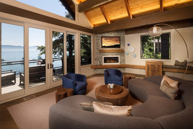 Mid-sized transitional open concept medium tone wood floor family room photo in San Francisco with beige walls, a ribbon fireplace, a stone fireplace and a wall-mounted tv
