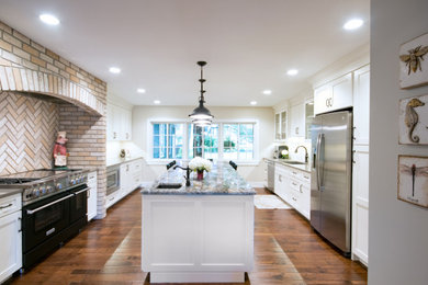 Example of a transitional brown floor eat-in kitchen design in Grand Rapids with an undermount sink, shaker cabinets, white cabinets, granite countertops, stainless steel appliances, an island and multicolored countertops