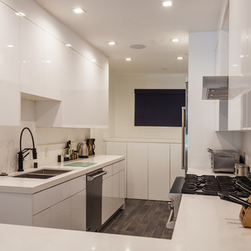 Glossy White Galley Kitchen With Gas Cooktop