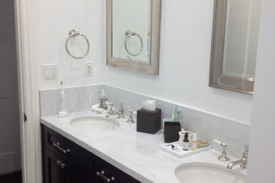 Photo of a mid-sized traditional master bathroom in San Francisco with recessed-panel cabinets, black cabinets, white walls, an undermount sink, quartzite benchtops, an alcove shower, marble, mosaic tile floors, white floor and a hinged shower door.