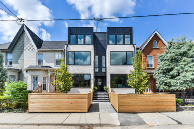 This is an example of a mid-sized contemporary three-storey multi-coloured exterior in Toronto with mixed siding and a flat roof.