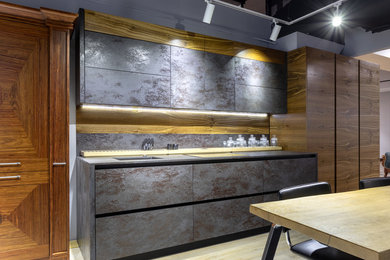This is an example of a small industrial single-wall separate kitchen in Moscow with no island.