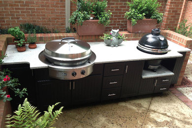 Example of a mid-sized transitional backyard concrete paver patio kitchen design in Atlanta with no cover