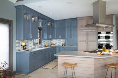 Large transitional l-shaped eat-in kitchen photo in New York with an undermount sink, flat-panel cabinets, quartz countertops, multicolored backsplash, paneled appliances, an island and gray countertops
