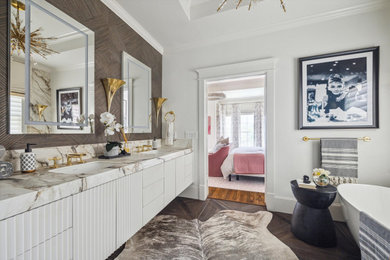 Example of a large transitional master brown tile and porcelain tile porcelain tile, brown floor and double-sink bathroom design in Houston with white cabinets, a two-piece toilet, white walls, an undermount sink, quartz countertops, a hinged shower door, white countertops and a floating vanity