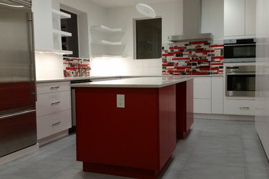 Inspiration for a mid-sized contemporary u-shaped ceramic tile and gray floor enclosed kitchen remodel in DC Metro with an undermount sink, flat-panel cabinets, white cabinets, quartzite countertops, multicolored backsplash, ceramic backsplash, stainless steel appliances and an island