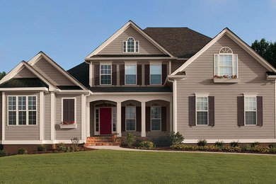 Large elegant blue three-story wood house exterior photo in Chicago with a clipped gable roof and a shingle roof