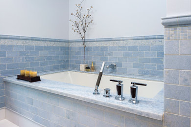 Inspiration for a transitional master bathroom in Detroit with an undermount tub, blue tile and stone tile.