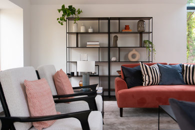 Design ideas for a large contemporary open plan living room in Essex with white walls, carpet, beige floors and a vaulted ceiling.