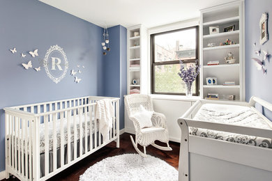 Photo of a transitional nursery in New York with brown floor.
