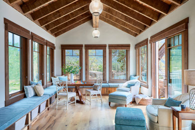 Inspiration for a large rustic conservatory in Denver with light hardwood flooring and brown floors.