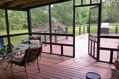 Deck - large cottage backyard deck idea in Other with a roof extension