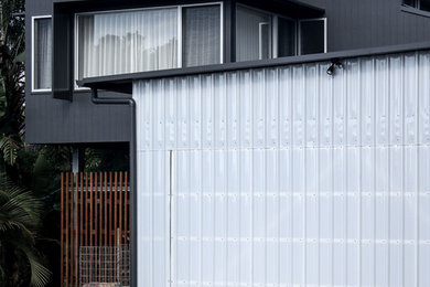 This is an example of a mid-sized contemporary detached two-car carport in Brisbane.