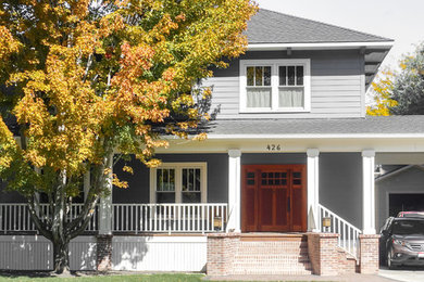 Mid-sized gray three-story concrete fiberboard house exterior idea in Boise with a hip roof and a shingle roof