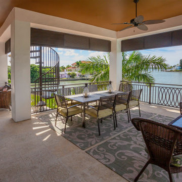 Waterfront Patio With Spiral Staircase And Outdoor Dining Area