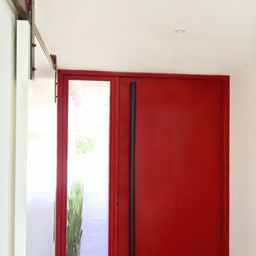 Red Steel Pivot Door on a Modern Masterpiece in La Costa