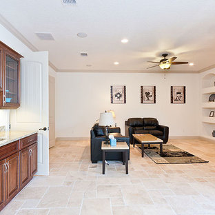 Photo of a large coastal open plan home cinema in Orlando with white walls, travertine flooring and a built-in media unit.