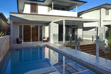 Inspiration for a large contemporary backyard rectangular aboveground pool in Sydney with decking.