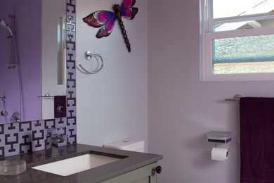 Inspiration for a small 1950s 3/4 pink tile and ceramic tile porcelain tile, purple floor and single-sink bathroom remodel in San Diego with shaker cabinets, gray cabinets, a one-piece toilet, purple walls, a pedestal sink, quartz countertops, gray countertops and a floating vanity
