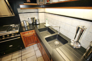 Cette image montre une cuisine design avec un évier de ferme et un plan de travail en granite.