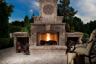Patio - mid-sized traditional backyard stone patio idea with a fire pit and no cover