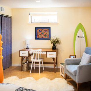 This is an example of a mid-sized tropical master bedroom in San Francisco with yellow walls, cork floors, no fireplace and brown floor.