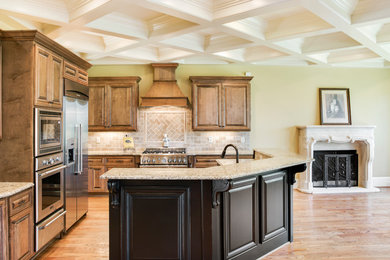 Huge elegant l-shaped dark wood floor and brown floor kitchen photo in Charlotte with an undermount sink, raised-panel cabinets, dark wood cabinets, granite countertops, beige backsplash, ceramic backsplash, stainless steel appliances and an island