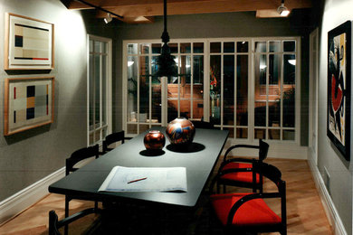 Inspiration for a mid-sized modern freestanding desk medium tone wood floor study room remodel in Other with gray walls
