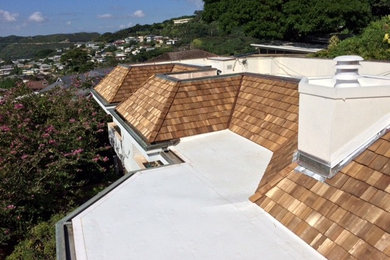 Example of a huge arts and crafts white two-story wood flat roof design in Hawaii