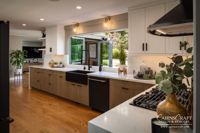 Example of a large minimalist l-shaped medium tone wood floor and brown floor eat-in kitchen design in San Diego with a farmhouse sink, flat-panel cabinets, medium tone wood cabinets, quartz countertops, white backsplash, quartz backsplash, black appliances, a peninsula and white countertops