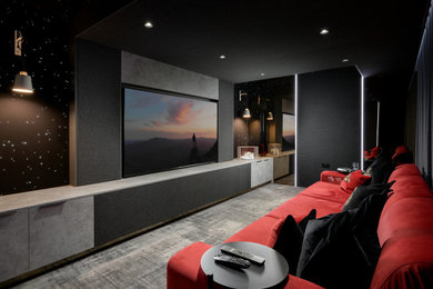 This is an example of a small contemporary home cinema in Essex with carpet, a built-in media unit and grey floors.