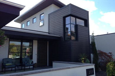 This is an example of a large modern two-storey grey house exterior in Boise with mixed siding and a flat roof.
