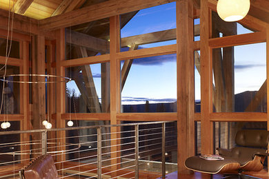 Inspiration for a rustic loft-style medium tone wood floor family room remodel in Denver