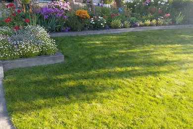 This is an example of a mid-sized contemporary full sun front yard garden path in Calgary for summer.