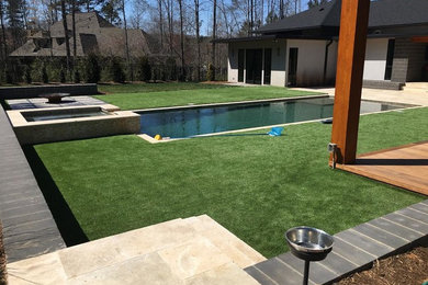 Hot tub - large contemporary backyard stone and rectangular lap hot tub idea in Charlotte