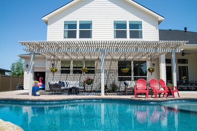 Large elegant backyard patio photo in Boise with a pergola
