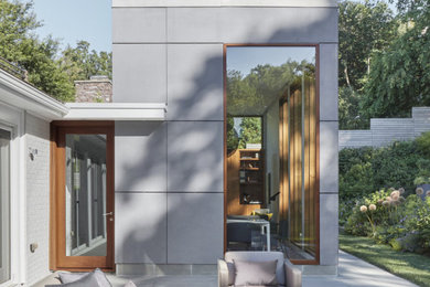 Example of a trendy gray one-story concrete fiberboard exterior home design in Boston