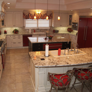 Traditional white kitchen with bright red appliances & accents & carved accents