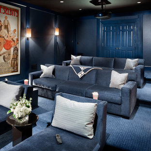 This is an example of a large classic enclosed home cinema in New York with blue walls, carpet, a projector screen and blue floors.