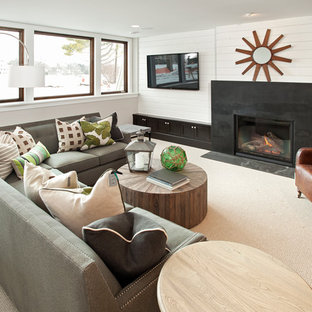 Inspiration for a medium sized traditional look-out basement in Minneapolis with white walls, carpet, a standard fireplace, a metal fireplace surround and white floors.