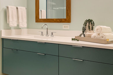 Mid-sized trendy master multicolored floor and single-sink bathroom photo in Minneapolis with flat-panel cabinets, blue cabinets, a one-piece toilet, blue walls, an undermount sink, quartz countertops, white countertops and a floating vanity