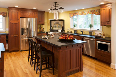 Inspiration for an arts and crafts u-shaped eat-in kitchen in Boston with dark wood cabinets and with island.